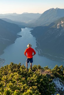 Young man looking over mountain landscape