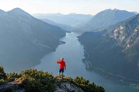 Young man looking over mountain landscape