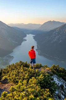 Young man looking over mountain landscape