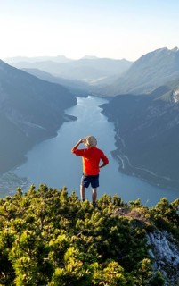Young man looking over mountain landscape