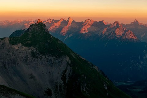 Summit of the Pfeilspitze in the foreground and Hornbachkette in the background at sunrise