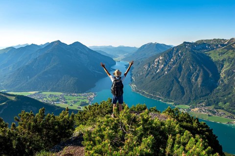 Hiker stretches arms in the air