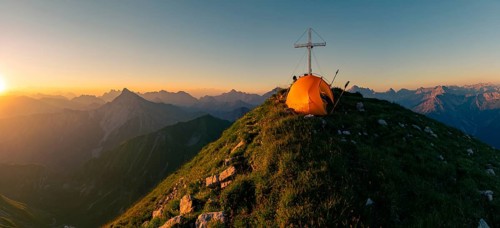 Cross of the Kreuzspitze with tent at the summit