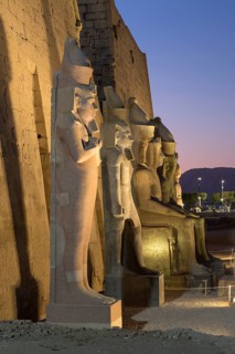 Temple of Luxor at dusk with colossal statues of Ramses ll