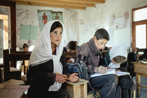 Three pupils in a school desk