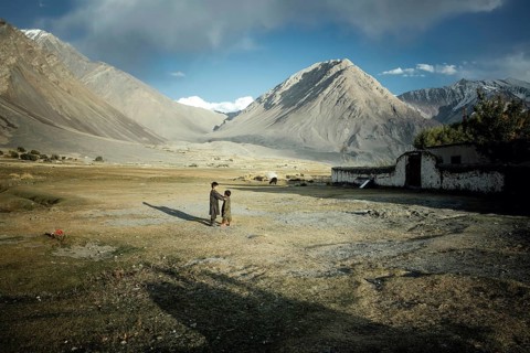Two boys playing on the threshing floor during the wheat harvest
