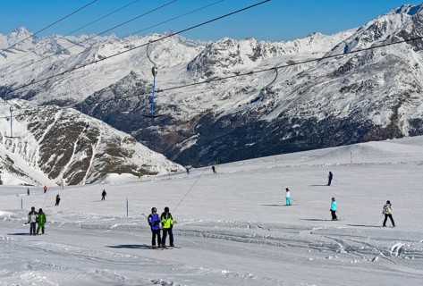 Skiers on the ski slope on the Fee glacier