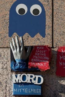 Outstretched hand and writing Murder in the Mediterranean Sea