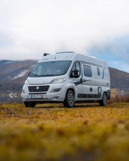 Campervan parked in the parking lot at Fjordbotn Camping