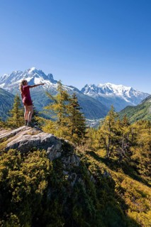 Hiker pointing at mountain panorama
