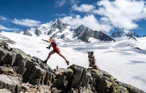 Hiker sprinting over rocks