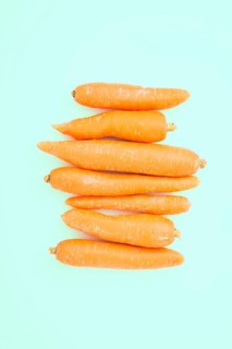 Raw yellow beets on turquoise background