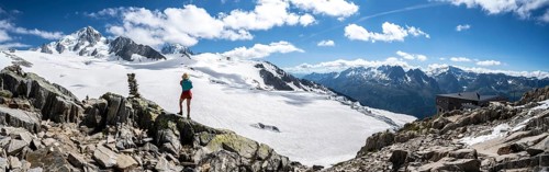 Hiker standing in front of glacier