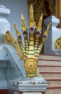 Five-headed mythological Naga serpent decorates the end of a stair railing