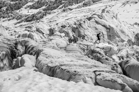 Climber walking on rutted glacier