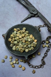 Green Malabar pepper in weighing pan