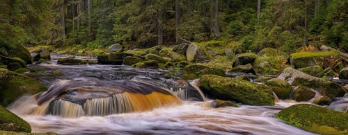 Waterfall at the Vydra with huge boulders in the riverbed