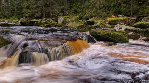 Waterfall at the Vydra with huge boulders in the riverbed