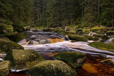 Waterfall at the Vydra with huge boulders in the riverbed