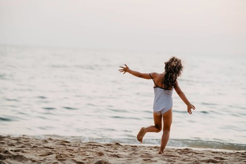 Happy girl on sandy beach