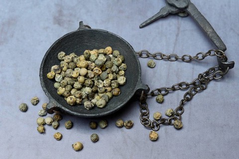 Green Malabar pepper in weighing pan