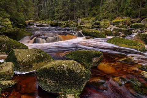 Waterfall at the Vydra with huge boulders in the riverbed