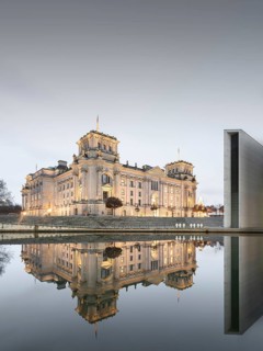 Reichstag with waving German flag at the Spree