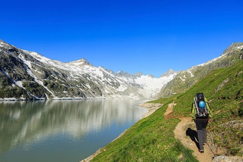 Mountaineer at the Oberaarsee in the direction of Oberaar Glacier