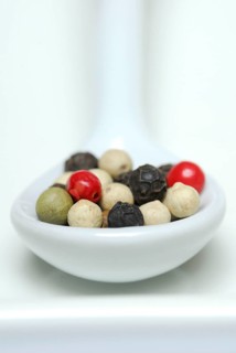 Peppercorns in porcelain spoon