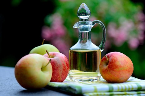 Carafe with apple vinegar and apples