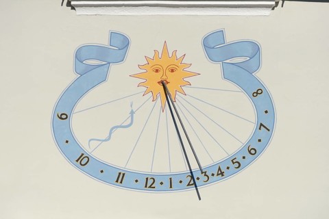 Sundial on house wall