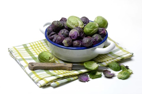 Purple and green Brussels sprouts in a bowl