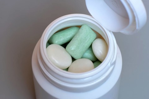 Various chewing gums in containers