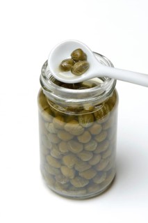 Glass and porcelain spoon with capers