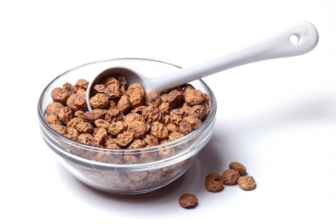 Tigernuts with porcelain spoon in bowl