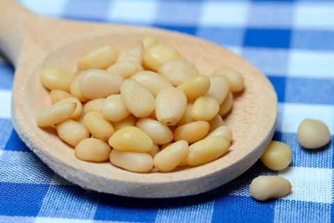 Cedar seeds with cooking spoon