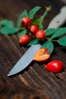 Rose hips with kitchen knife
