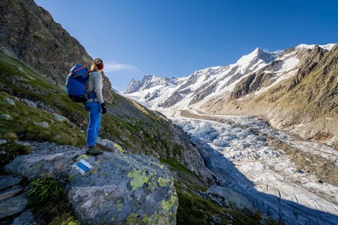 Mountaineer standing in front of glacier