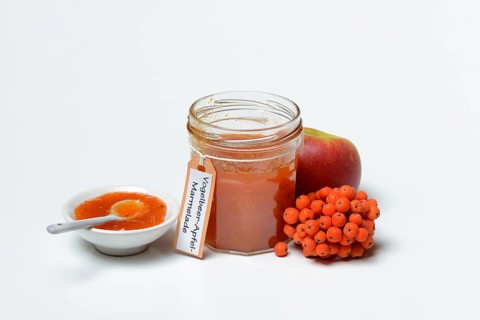 Glass of rowanberry and apple jam with n