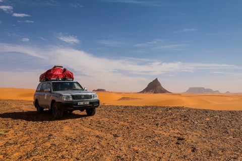 Expedition jeep driving through the desert