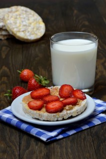Corn and rice waffle topped with strawberries and peanut butter