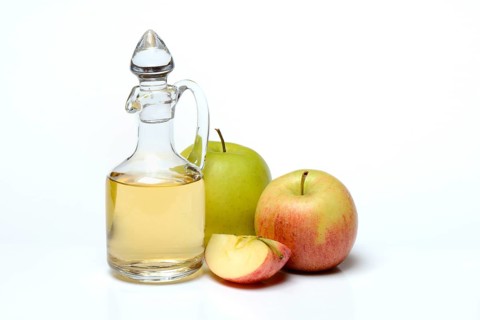 Carafe with apple vinegar and apples