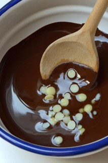 Liquid chocolate coating and melting cocoa butter with spoon