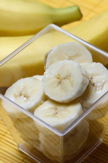Banana slices in peel and bananas