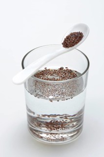 Glass of water and spoon with psyllium
