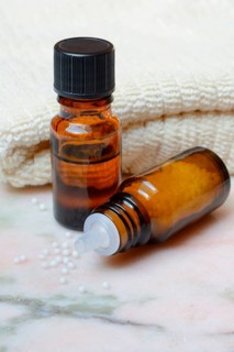 Five medicine bottles containing different homeopathic remedies