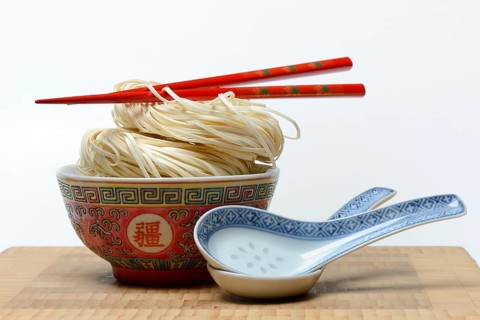 Chinese Yangchun noodles in bowl with chopsticks and porcelain spoon