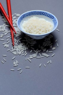 Rice grains in husk and chopsticks