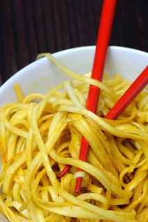 Chinese noodles in bowl with chopsticks