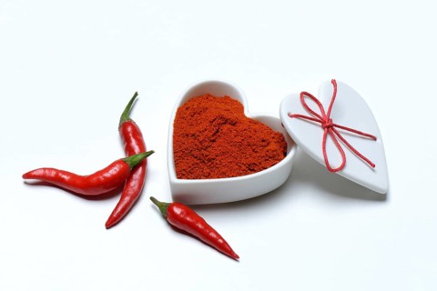 Chili powder in bowl with heart shape